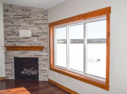 Newly installed replacement windows with wood grain frames.