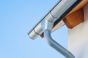 Corner of a house with custom half-round gutters.